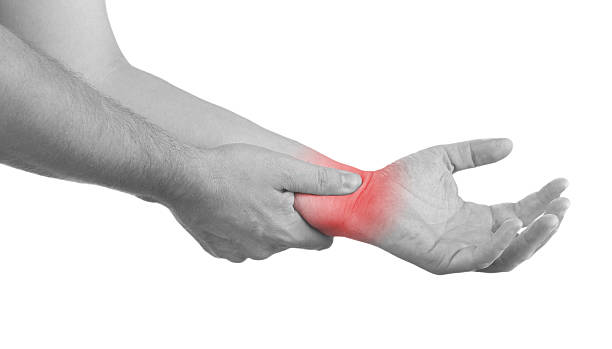 Pain in a man wrist. Male holding hand to spot of wrist pain.